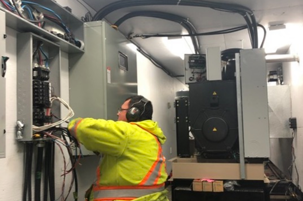 show a technician building and testing a custom generator container as part of our industrial mechanical services